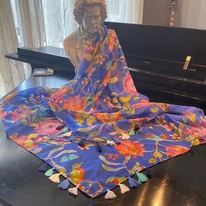 Wrap or scarf with tassel details on corners